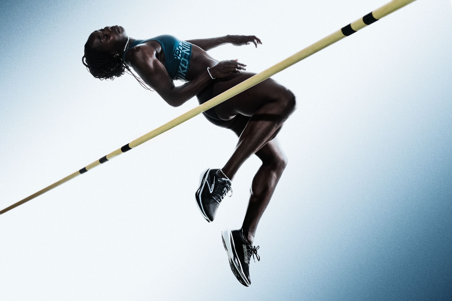 High jumper arching backwards over the bar